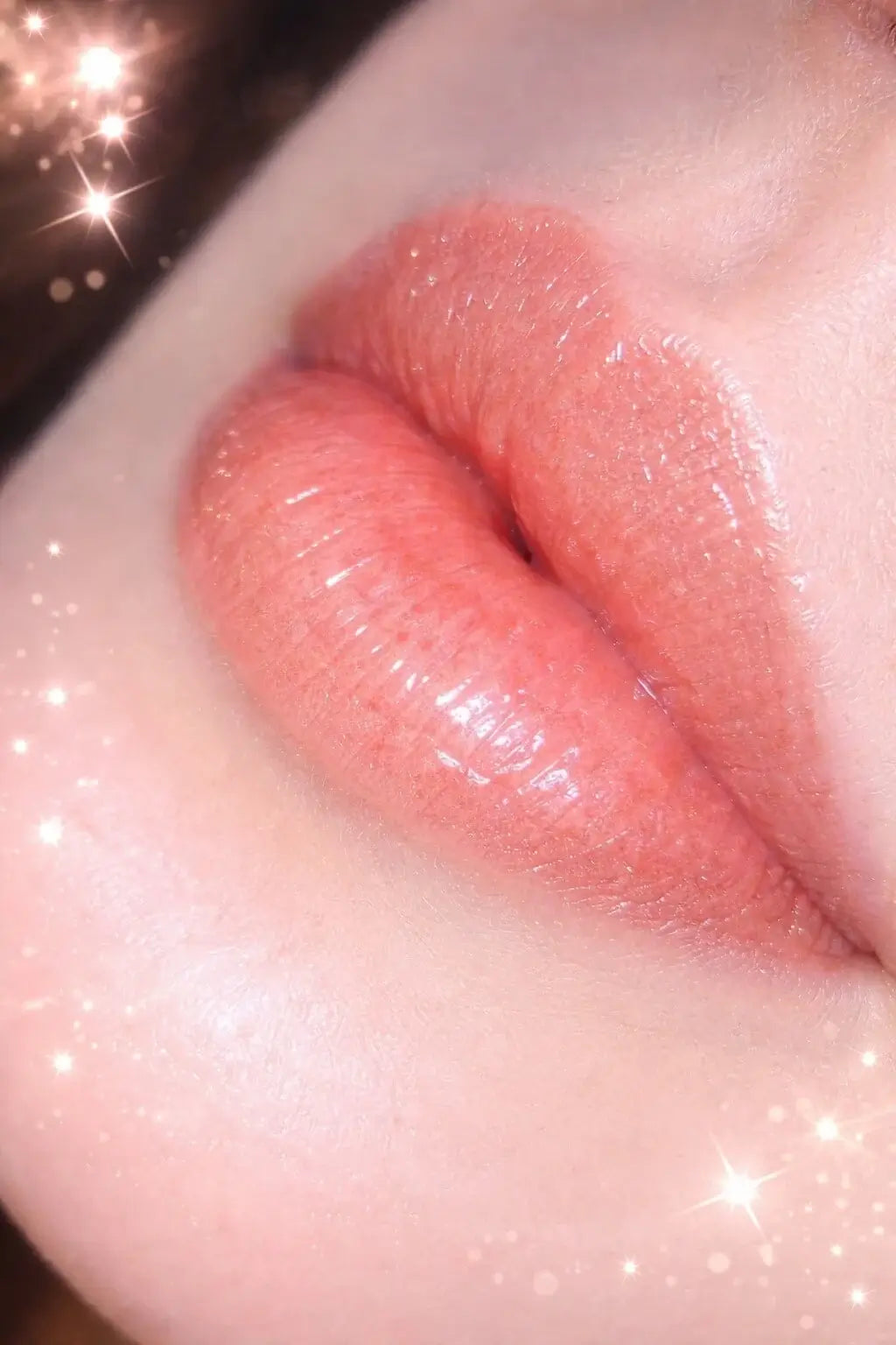 Close-up of glossy lips wearing YNH Glow lip gloss