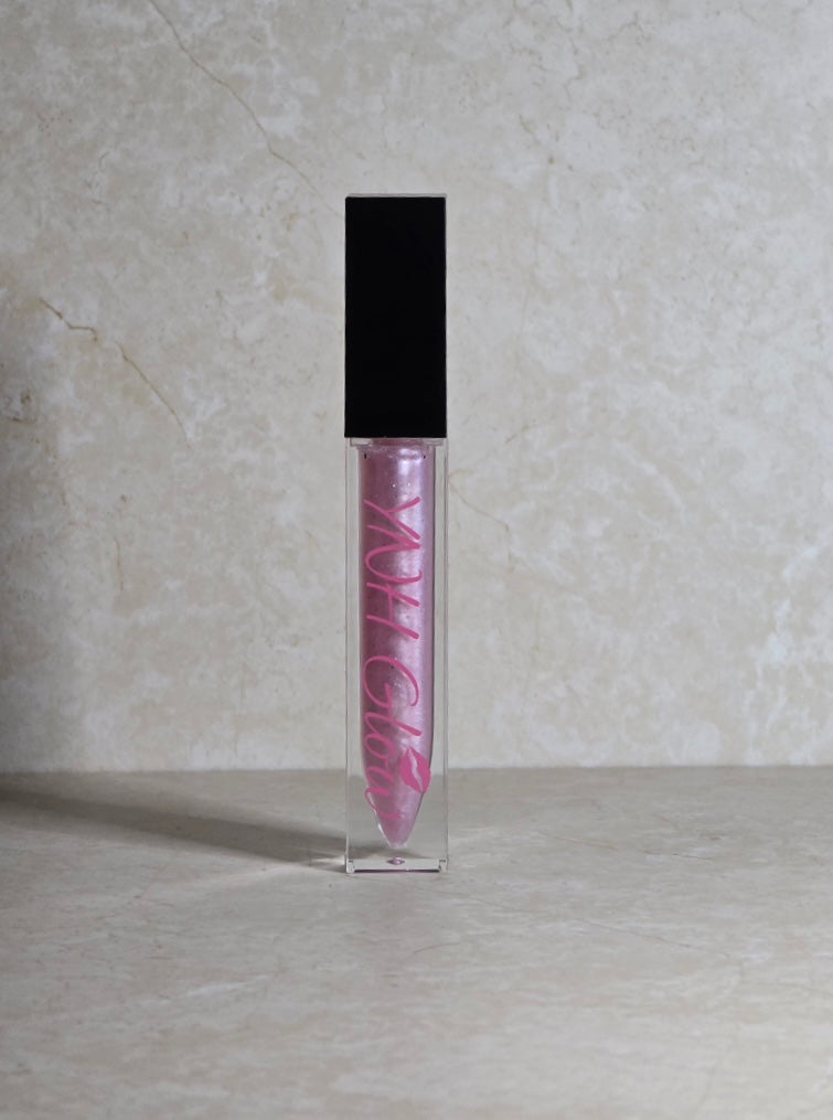 Cotton Candy Lip Gloss, by YNH Glow, in a clear tube, with a sparkling, glossy finish and a soft, light pink hue